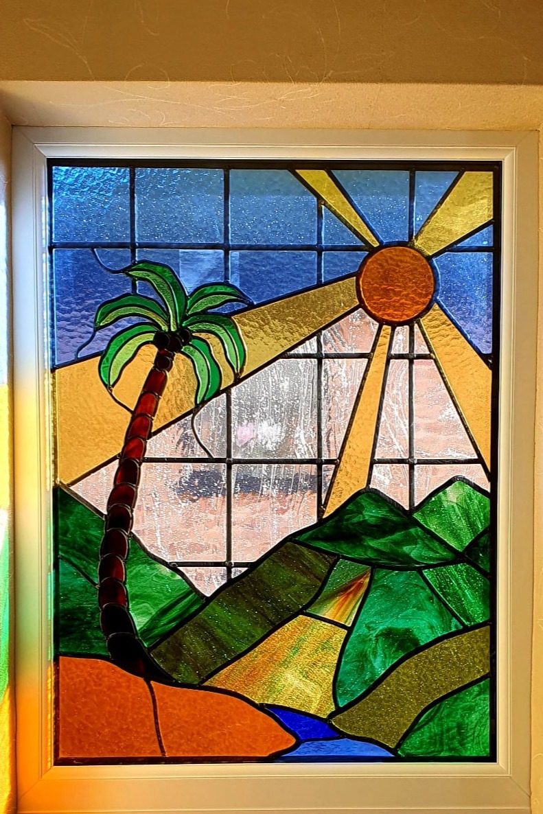 Bay window with decorative leaded glass showing bright colours and sun rays
