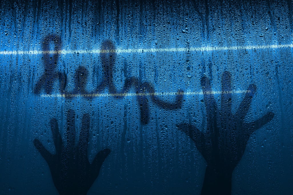 Condensation‑covered glass with the word “help” and two handprints wiped into the mist — highlighting emergency glazing and misted‑glass replacement services in Great Eccleston.